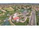 Community aerial view showcasing golf course, tennis courts, clubhouse, and scenic ponds at 9447 W Tonto Ln, Peoria, AZ 85382