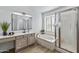 Elegant bathroom with soaking tub, walk-in shower, and modern vanity at 9447 W Tonto Ln, Peoria, AZ 85382