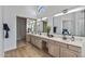 Double vanity bathroom with a large mirror and ample storage at 9447 W Tonto Ln, Peoria, AZ 85382
