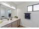 Bathroom with vanity, mirror, and large window at 9447 W Tonto Ln, Peoria, AZ 85382