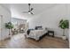 Spacious bedroom featuring wood floors and a ceiling fan at 9447 W Tonto Ln, Peoria, AZ 85382