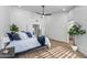 Serene bedroom with wood floors and ample natural light at 9447 W Tonto Ln, Peoria, AZ 85382