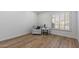 Bright bedroom with wood floors, large window and comfortable recliner at 9447 W Tonto Ln, Peoria, AZ 85382