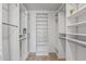 Large walk-in closet with custom shelving and hanging rods at 9447 W Tonto Ln, Peoria, AZ 85382