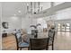 Dining area with round table, chandelier, and view of living room at 9447 W Tonto Ln, Peoria, AZ 85382