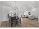 Open concept dining area with a round table and chandelier at 9447 W Tonto Ln, Peoria, AZ 85382