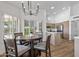 Kitchen and dining area with modern chandelier and wood flooring at 9447 W Tonto Ln, Peoria, AZ 85382