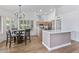 Eat-in kitchen with island, modern appliances, and wood flooring at 9447 W Tonto Ln, Peoria, AZ 85382