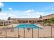 Community pool with lounge chairs and a gate at 9447 W Tonto Ln, Peoria, AZ 85382