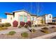 Tan house with red flowers and a two-car garage at 9948 E Strobe Ave, Mesa, AZ 85212