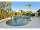 Large kidney shaped pool with waterfall feature at 10190 E Sunnyside Dr, Scottsdale, AZ 85260