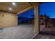 Covered patio area with pavers and view of grassy backyard at 10393 W Rosewood Ln, Peoria, AZ 85383