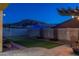 Backyard at night with artificial turf and pergola at 10393 W Rosewood Ln, Peoria, AZ 85383