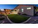 Artificial turf backyard with pergola, fire pit, and patio at 10393 W Rosewood Ln, Peoria, AZ 85383