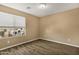 Cozy bedroom with wood-look floors and window view at 11131 W Mariposa Dr, Phoenix, AZ 85037