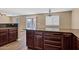 Kitchen island with granite countertops and dark wood cabinets at 11131 W Mariposa Dr, Phoenix, AZ 85037