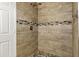 Updated shower with tile surround and pebble floor at 11131 W Mariposa Dr, Phoenix, AZ 85037