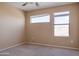 Bright bedroom with carpet flooring and two windows at 11640 N 51St Ave # 204, Glendale, AZ 85304