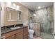 Updated bathroom with a walk-in shower and dark vanity at 13051 W Blue Sky Dr, Sun City West, AZ 85375