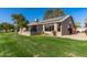 Home exterior with solar panels and lawn at 13051 W Blue Sky Dr, Sun City West, AZ 85375