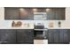Modern kitchen with dark cabinetry, stainless steel appliances, and ample counter space at 1344 W Inca Dr, Coolidge, AZ 85128