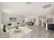 Open living room with wood-look floors and access to kitchen and dining area at 1344 W Inca Dr, Coolidge, AZ 85128