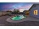 Inviting kidney-shaped pool in backyard at dusk at 1363 N Terripin St, Mesa, AZ 85207