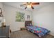 Cozy bedroom with a twin-sized bed and window seat at 1409 E Harvest Rd, San Tan Valley, AZ 85140