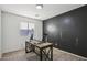 Home office with a large desk and dark accent wall at 1409 E Harvest Rd, San Tan Valley, AZ 85140
