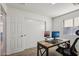 Spacious bedroom with wood desk and built-in closet at 1409 E Harvest Rd, San Tan Valley, AZ 85140