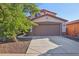 Two-story house with brown garage door and landscaping at 1409 E Harvest Rd, San Tan Valley, AZ 85140