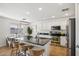 Kitchen with island, stainless steel appliances, and white cabinets at 1409 E Harvest Rd, San Tan Valley, AZ 85140