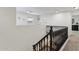 Upstairs hallway with dark wood railing and carpet flooring at 1409 E Harvest Rd, San Tan Valley, AZ 85140