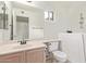 Bathroom with a vanity, toilet, and walk-in bathtub at 1427 E Irwin Ave, Phoenix, AZ 85042