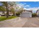 House front with a gray garage door and landscaping at 1427 E Irwin Ave, Phoenix, AZ 85042
