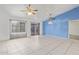 Bright living room with tile flooring, ceiling fans, and access to the backyard at 1427 E Irwin Ave, Phoenix, AZ 85042