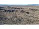 Aerial view of a desert landscape with rocky terrain at 14952 S 184Th Ave, Goodyear, AZ 85338