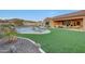 Stunning backyard with a pool, fire pit, and expansive grassy area at 14952 S 184Th Ave, Goodyear, AZ 85338