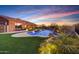 Inviting swimming pool with a fountain and artificial turf at 14952 S 184Th Ave, Goodyear, AZ 85338