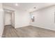 Bright and airy bedroom with vinyl wood flooring and neutral walls at 17449 W El Caminito Dr, Waddell, AZ 85355