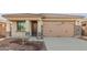Single-story home with attached garage and desert landscaping at 17449 W El Caminito Dr, Waddell, AZ 85355