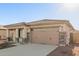 New construction home with attached garage and stone accents at 17449 W El Caminito Dr, Waddell, AZ 85355