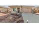 Front yard view of charming house with attached garage at 17449 W El Caminito Dr, Waddell, AZ 85355