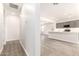 Bright hallway with wood-look flooring at 17449 W El Caminito Dr, Waddell, AZ 85355