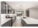 Modern kitchen with stainless steel appliances and gray cabinets at 17449 W El Caminito Dr, Waddell, AZ 85355
