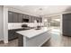 Spacious kitchen with island, stainless steel appliances, and backyard access at 17449 W El Caminito Dr, Waddell, AZ 85355