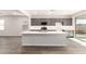 Open concept kitchen featuring a large island and gray cabinetry at 17449 W El Caminito Dr, Waddell, AZ 85355