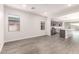 Open concept living area with grey kitchen cabinets and vinyl flooring at 17449 W El Caminito Dr, Waddell, AZ 85355
