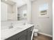 Bathroom featuring a double sink vanity, a large mirror, tiled floors, and a separated shower and tub at 17636 W Pierson St, Goodyear, AZ 85395