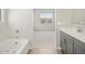 Bathroom featuring a soaking tub and a view of the bedroom at 17636 W Pierson St, Goodyear, AZ 85395
